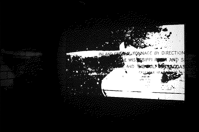 An image of a black and white projection featuring obscured text.